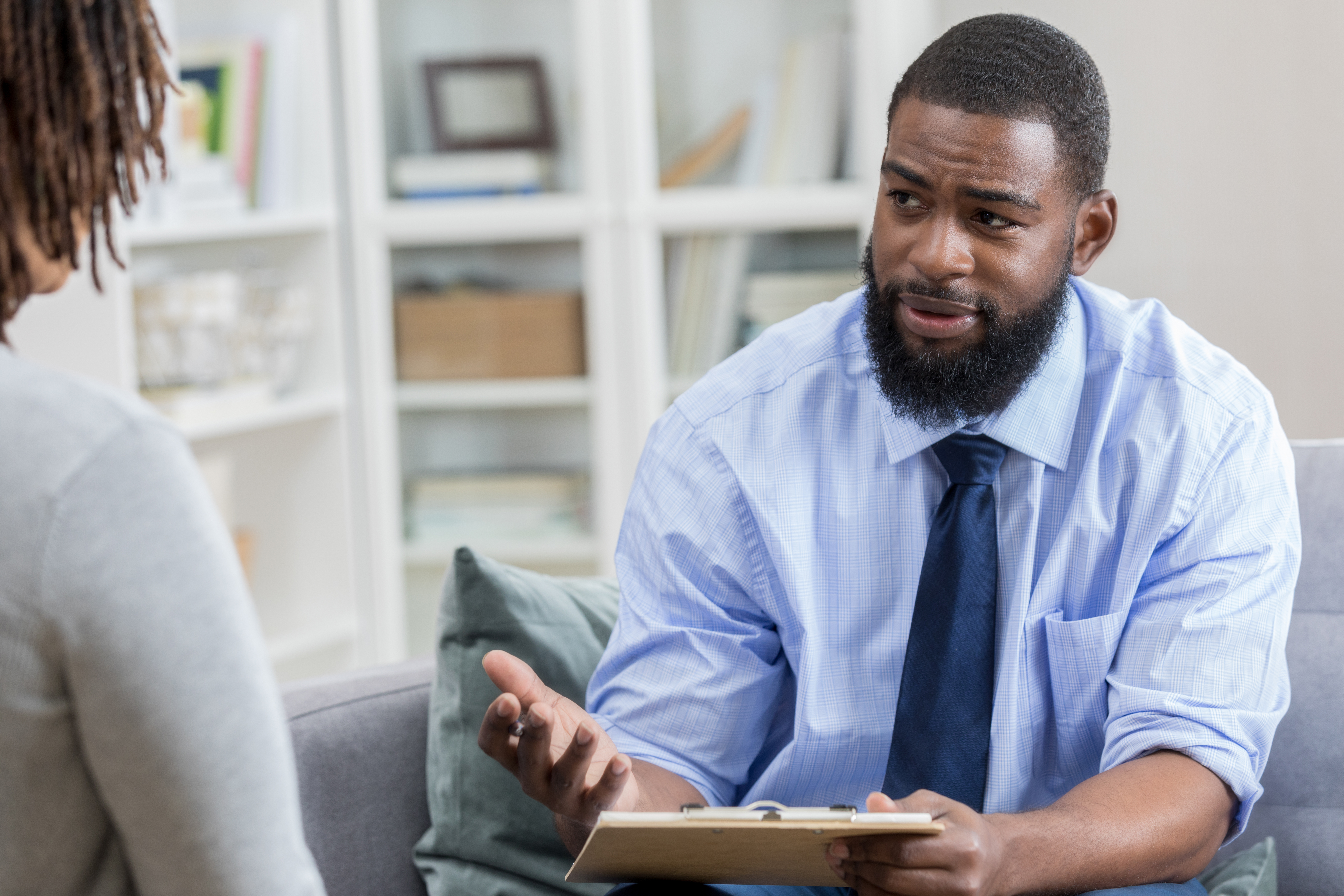 Mental health professional talks with female patient
