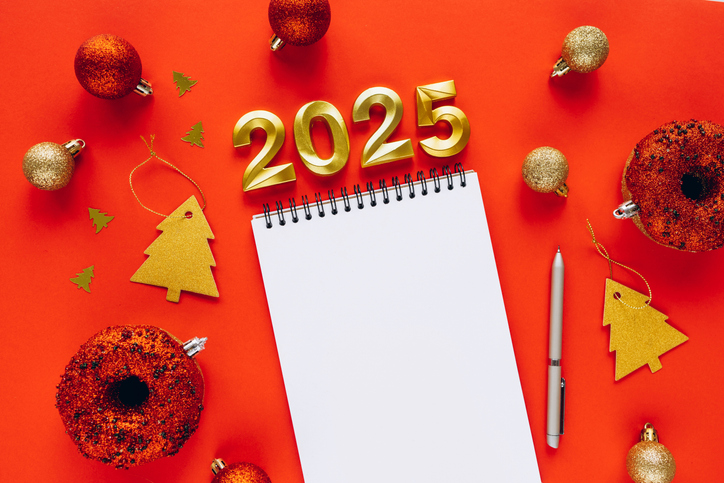 2025 New Year Flat Lay with Blank Notebook, Pen, and Festive Decorations on Red Background