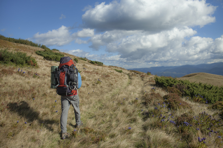 Man hiking long-distance hiking trail in remote mountains